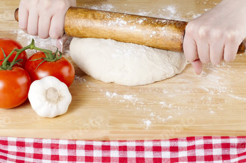 Preview: Image Of A Hand Holding A Rolling Pin To Knead The Pizza Dough On The Wooden Table