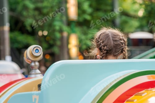Vista previa: Child On A Carousel At A Carnival Or Festival At Sunset. Decorative Ornate Spaceships At An