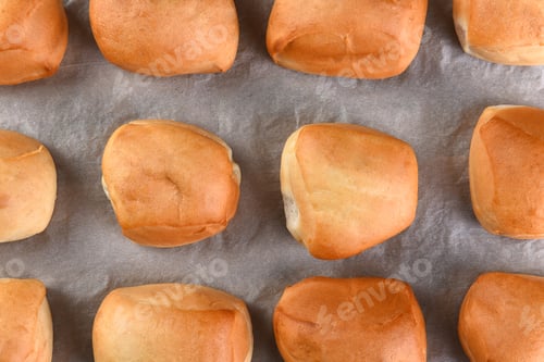 Preview: Closeup Top View Of Fresh Baked Dinner Rolls On Parchment Paper.