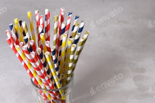 Preview: A Glass Filled With Multi Colored Eco-Friendly Paper Drinking Straws. Horizontal Format Gray