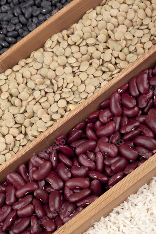 Preview: Close-Up Shot Of Coffee Beans Arranged To Form At Symbol On White Surface.