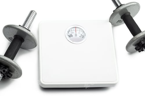Preview: Barbell Weights Beside Scales - Dieting And Exercise Concept