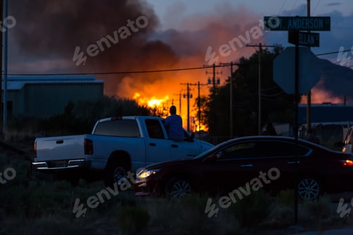 Preview: Large Warehouse Fire In The Distance Beyond Spectators Sitting In Their Cars Shallow Depth Of Field