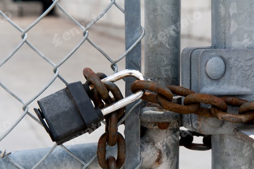 Preview: Heavy Industrial Padlock And Chain On A Gate In A Chain Link Fence