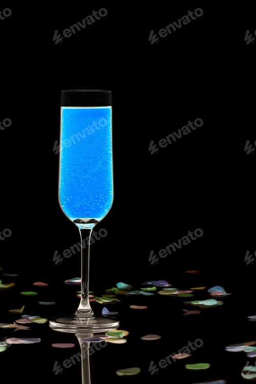 Preview: Close-Up Shot Of Blue Cocktail Drink With Colorful Confetti On Dark Background.