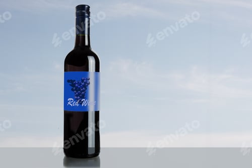 Preview: Dark Red Wine Bottle With Generic Label On A Blue Sky Background