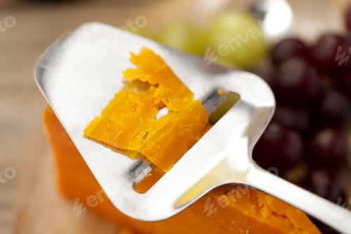 Preview: Macro Shot Of Cheese Knife Slicing A Cheese.