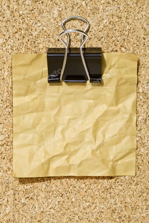 Preview: Wrinkled Yellow Memo Note With Black Binder Clip