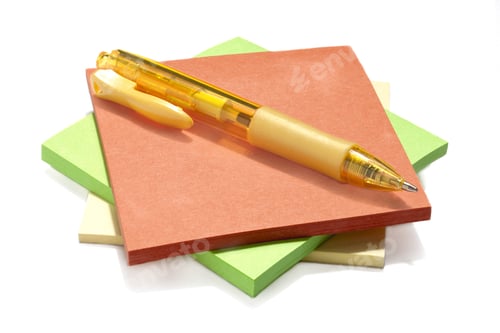 Preview: Isolated Image Of A Pile Of Sticky Note In Assorted Colors With A Pen On Top Against A White