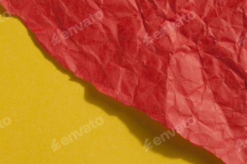 Preview: Close Up Image Of Ripped Crumple Red Paper Against Yellow Background