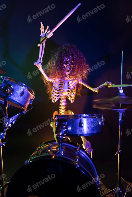 Preview: Skeleton In Long Haired Wig Plays Drums Wildly Lit By Orange And Green Light