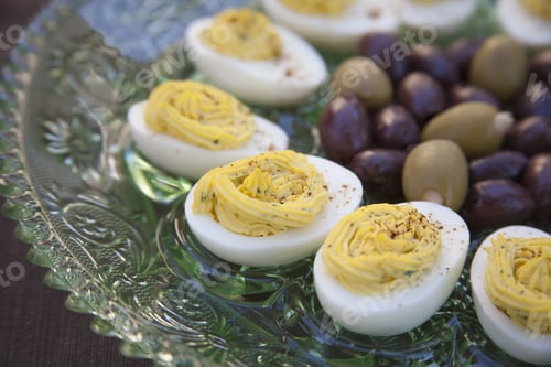 Preview: Marinated Kalamata Olives And Green Olives Stuffed With Garlic Served With Deviled Eggs Sprinkled