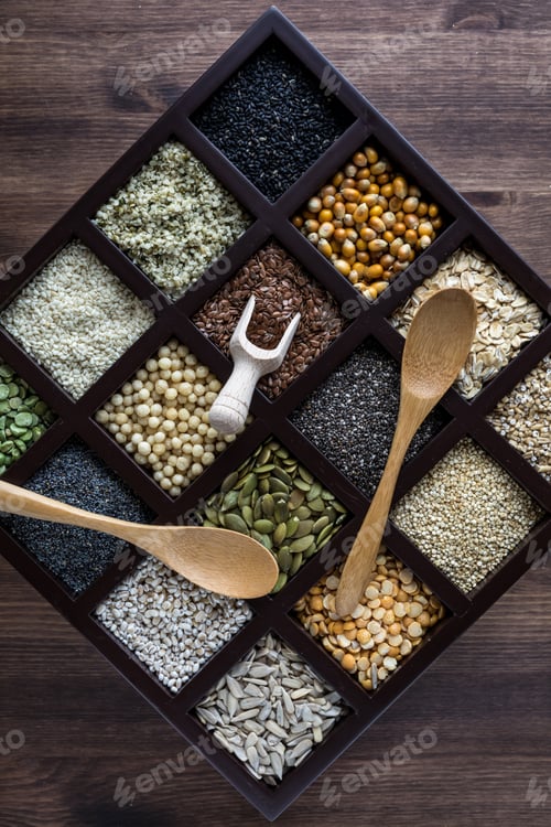 Preview: Top Down View Of A Wooden Box Filled With Compartments Of Seeds And Grains.