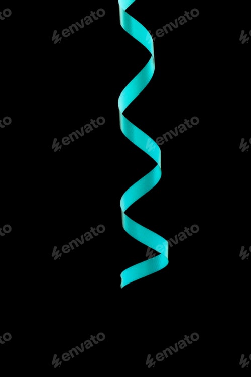Preview: Close-Up Of Curled Up Party Ribbon Isolated Over Black Background
