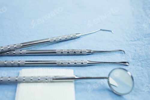 Preview: Dental Picks, Mirror And Gauze On A Paper Lined Tray
