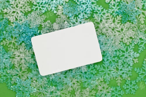 Preview: Close-Up Image Of A Christmas Card And Snowflakes In The Green Background