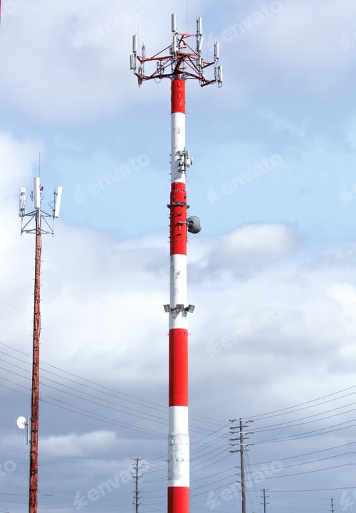 Preview: A Red And White Communication Tower With An Array Of Antennas By An Airport