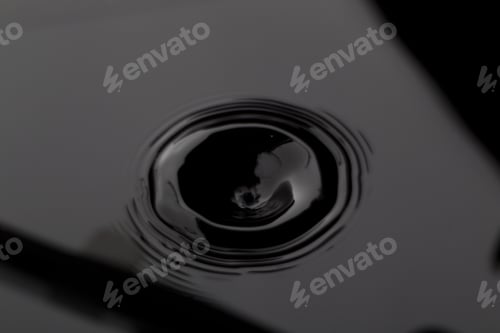 Preview: Close Up Water Droplet Affect The Surface, Forming Rings On The Surface And Making A Perfect