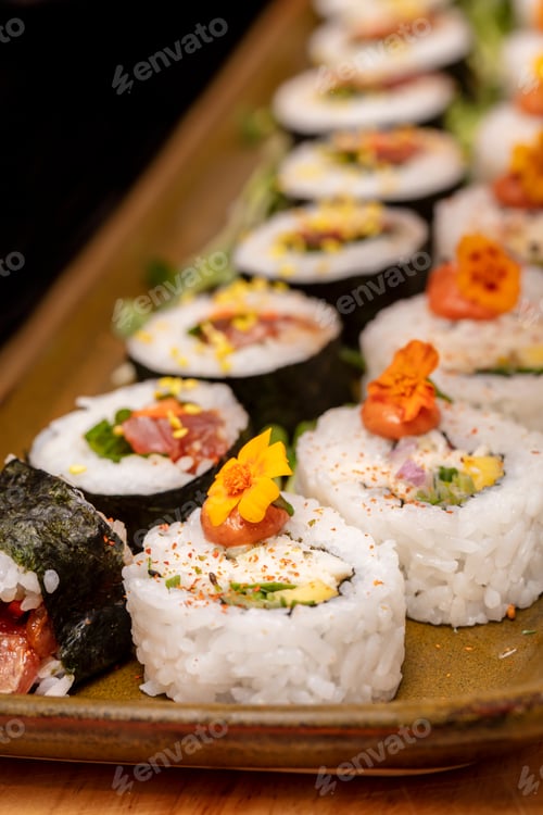 Preview: Cut Up Sushi Rolls Trimed With Flowers And Radish Roots Filled With Crab Meat And Tuna
