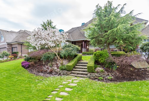 Preview: Beautiful Exterior Of Newly Built Luxury Home. Yard With Green Grass And Stone.