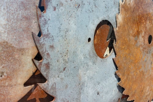 Preview: Old Rusty Circular Saw Blades Viewed Through A Shop Window