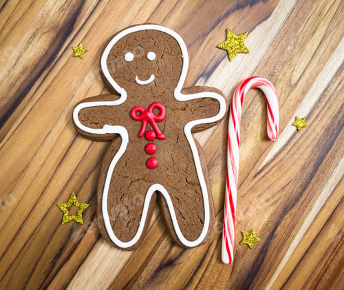 Preview: Holiday Classic, A Gingerbread Man With A Candy Cane Cookie On A Wooden Table