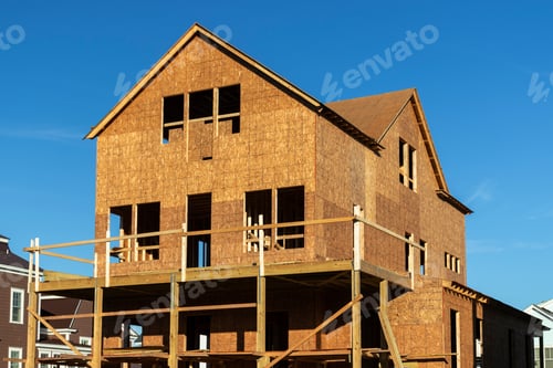 Aperçu: New House Construction Frame Against A Blue Sky