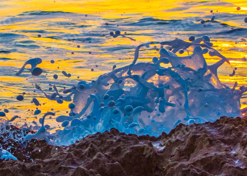 Preview: A Close Up Of Splashing Waves In The Morning Light As They Break Over Rocks On A Florida Beach