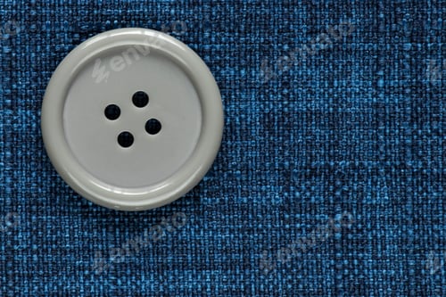 Preview: Clothes Sewing Button On A Blue Fabric Swatch Background