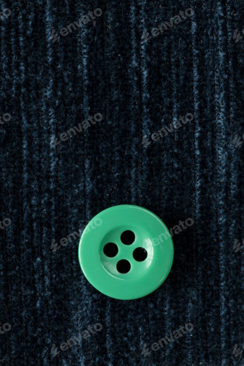 Preview: Clothes Sewing Button On A Blue Fabric Swatch Background
