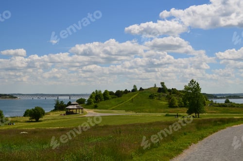 Preview: Lush Spectacle Island With Fluffy Clouds And Green Grass.