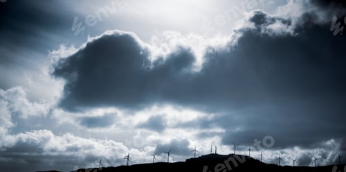 Preview: Silhouetted View Of Windmills Against Overcast Sky At Dusk