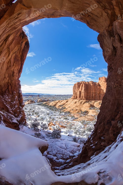 Preview: Looking Thru The Window At Double Arch In Arches National Park With Snow Covered Grounds