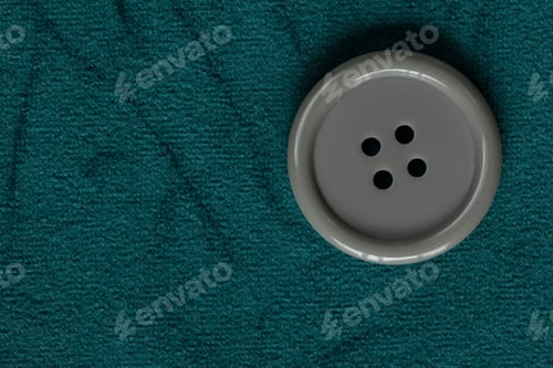 Preview: Clothes Sewing Button On A Blue Green Fabric Swatch Background