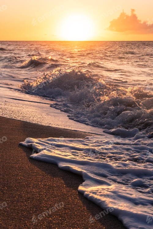 Preview: Sun Setting Over The Pacific Ocean With Waves Crashing On The Sand In The Foreground. Colorful Sun