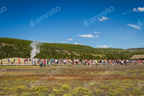 Preview: Yellowstone National Park, Wyoming - July 22 : Group Of Tourists Standing Watching Old Faithful