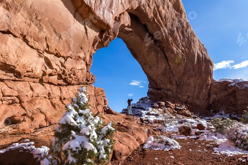 Preview: Beautiful Formation Known As North Window In Arches National Park With A Person Standing At The