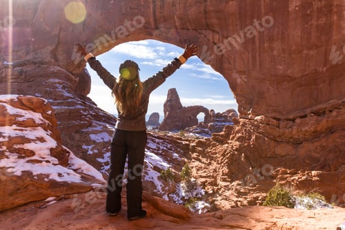 Preview: Woman In Fun Winter Gear Enjoying The View Of Turret Arch Thru North Window With Fresh Snow On The