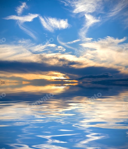 Preview: Beautiful Sunset With Vivid Blue Sky And Light Clouds Reflected Over Water