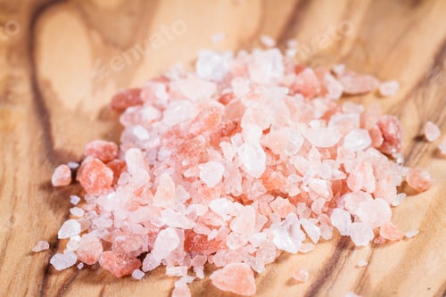 Preview: Himalayan Pink Salt Crystals Piled On A Wooden Cutting Board