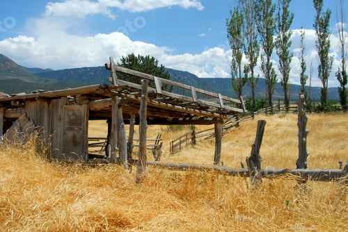 Preview: Southwestern Landscape Of Ruins Of An Old Abandoned Ranch With Stables And Dry Grass Framed In By