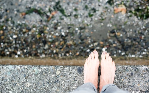 Preview: Bare Feet Standing On Cement Edge Near Water