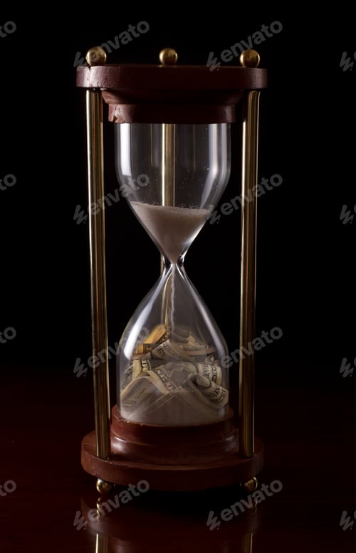 Preview: Hour Glass On A Dark Background With American Money In It