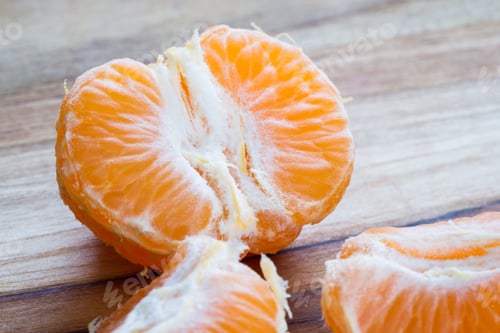 Preview: Close Up Of A Small Orange Or Tangerine On A Wooden Cutting Board