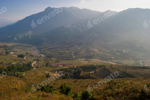 Preview: Rice Fields Terraces With Beautiful Mountains In The Background. Village At The Bottom Of The