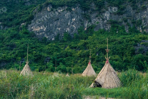 Preview: Traditional Native Villages Full Of Tipis Made Of Hay And Branches On An Island With Steep Cliffs