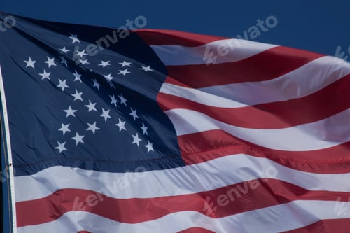 Preview: Waving Stars and Stripes Against a Blue Sky