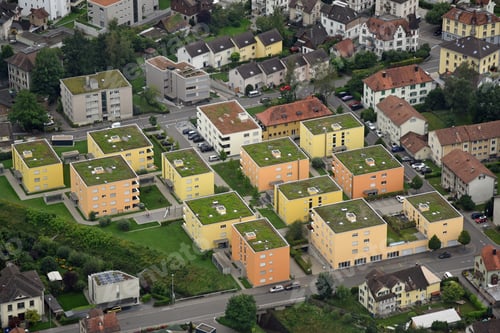 Preview: Aerial View Of 5-Story Residential Blocks Painted In Shades Of Yellow In Switzerland