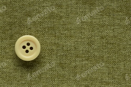 Preview: Clothes Sewing Button On A Green Fabric Swatch Background