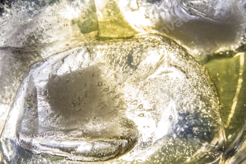 Preview: Back Lit Close Up Of Floating Ice Cubes In A Glass Of Whiskey